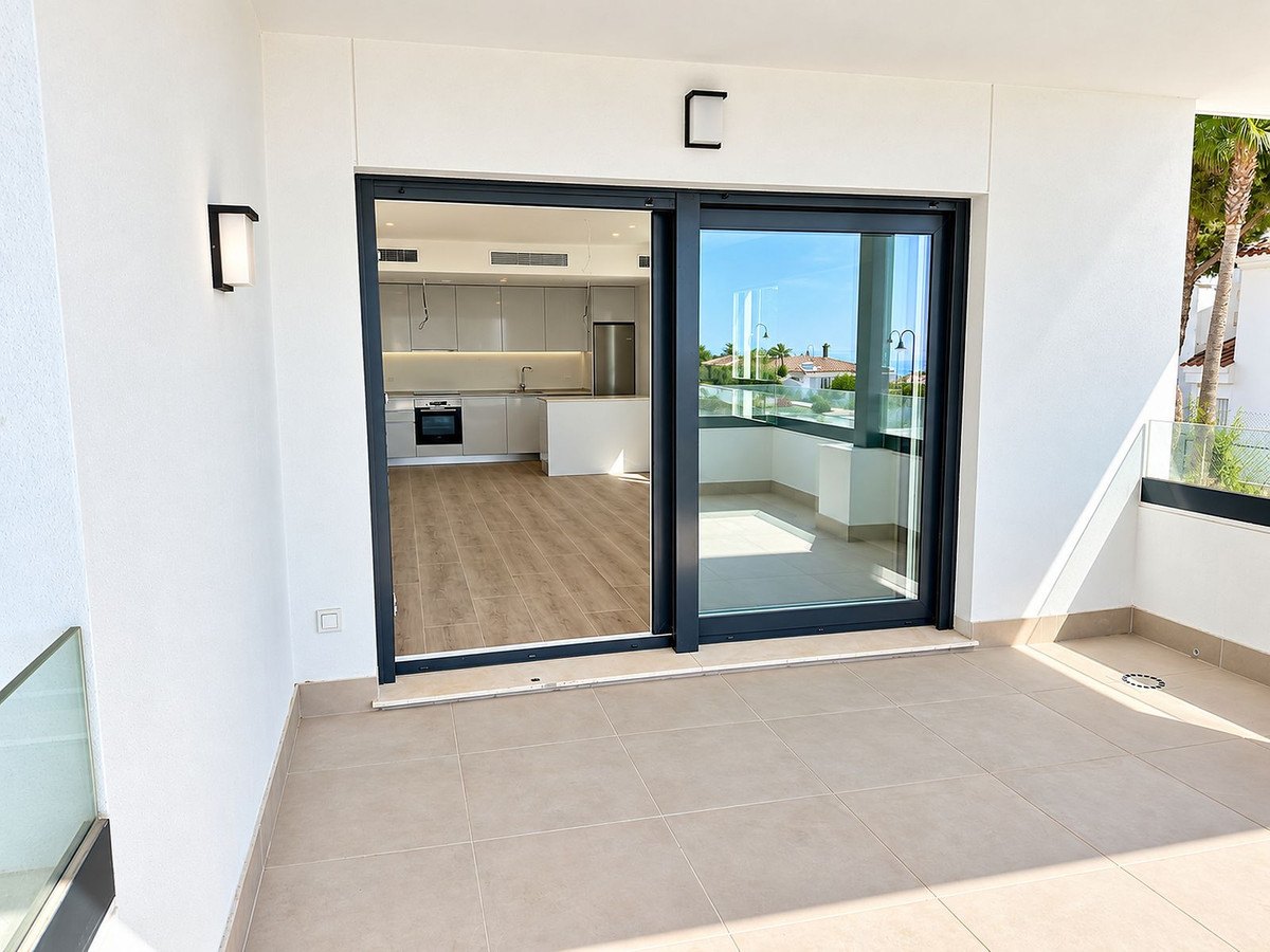 The living room opening to the covered terrace