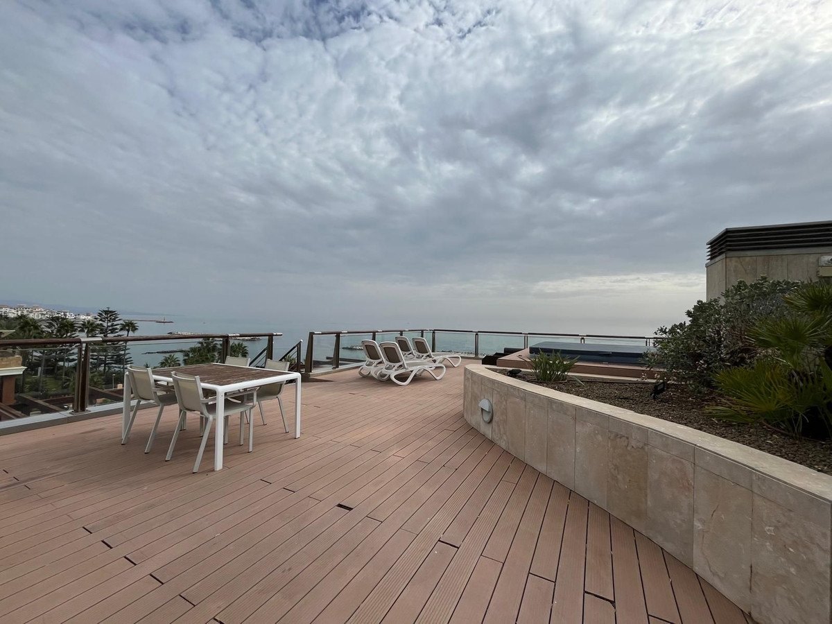 Dining on the roof, the sea behind