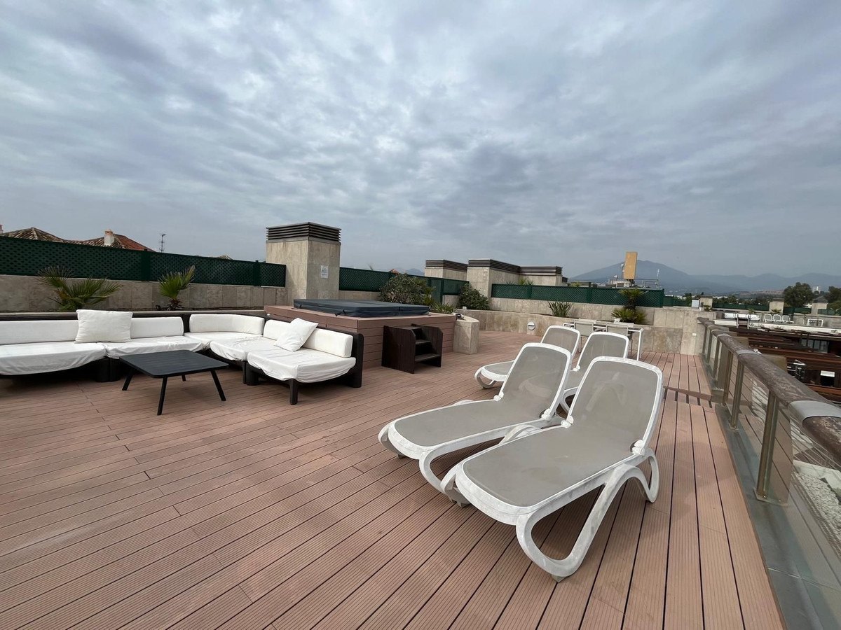 The roof deck with loungers and an outdoor lounge