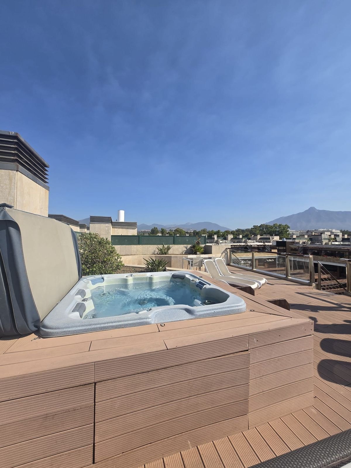 The rooftop jacuzzi on its timber deck, with La Concha on the horizon