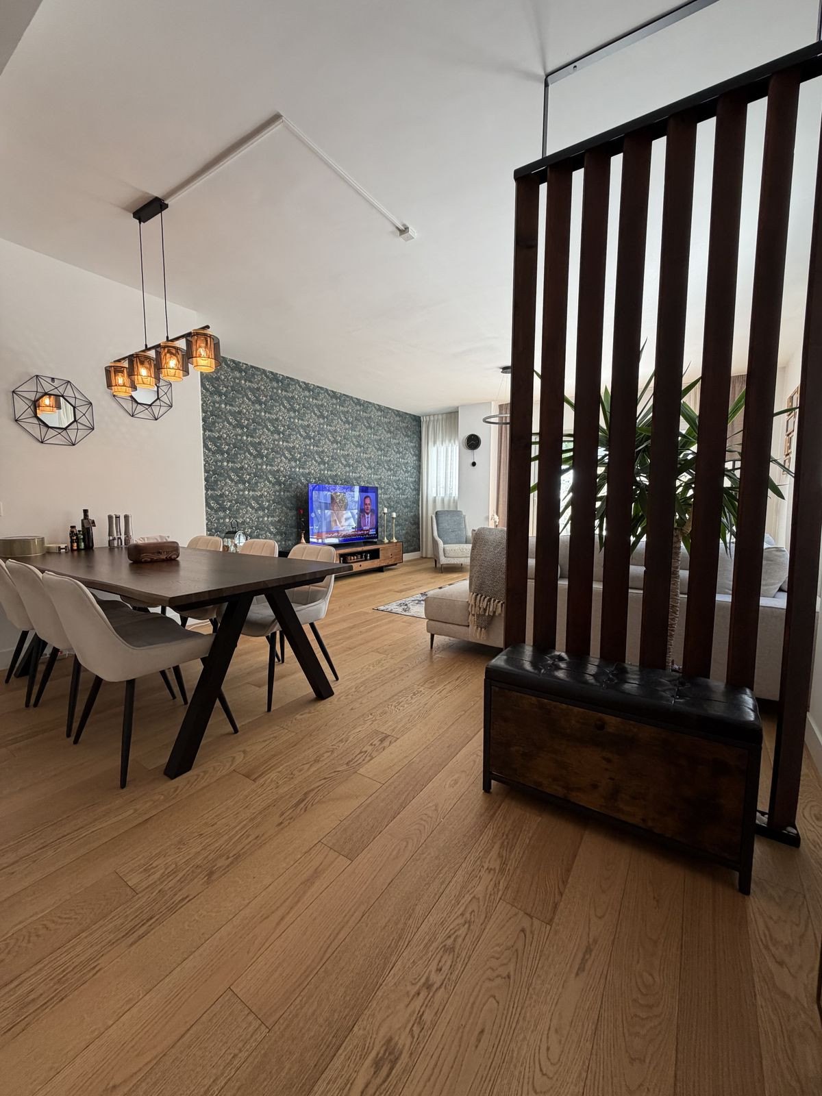 The dining table behind the timber-slat screen
