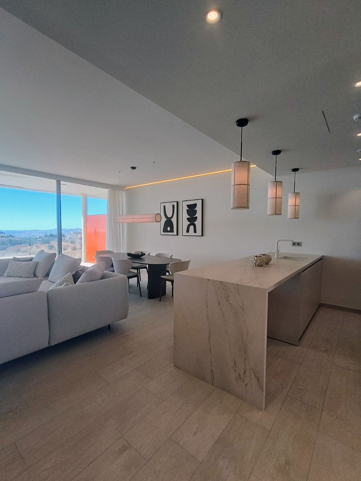 The living room with the sea beyond the windows