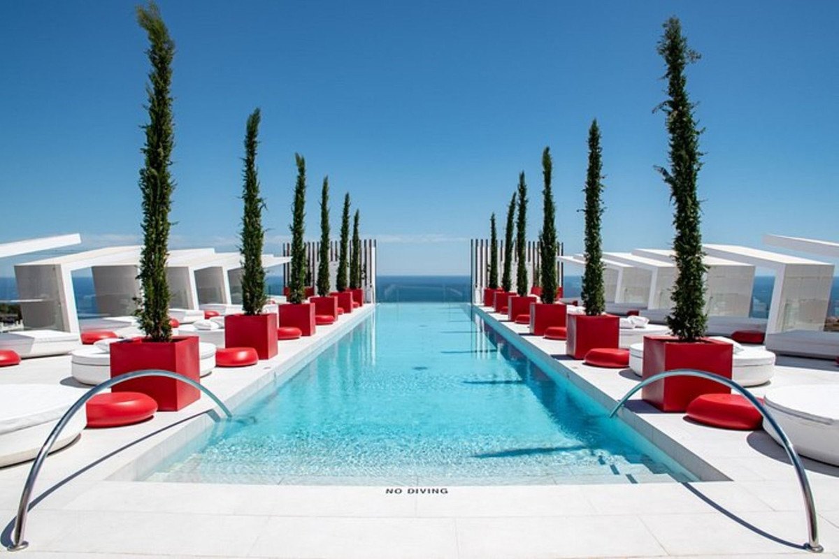 The resort's pool, lined with cypresses