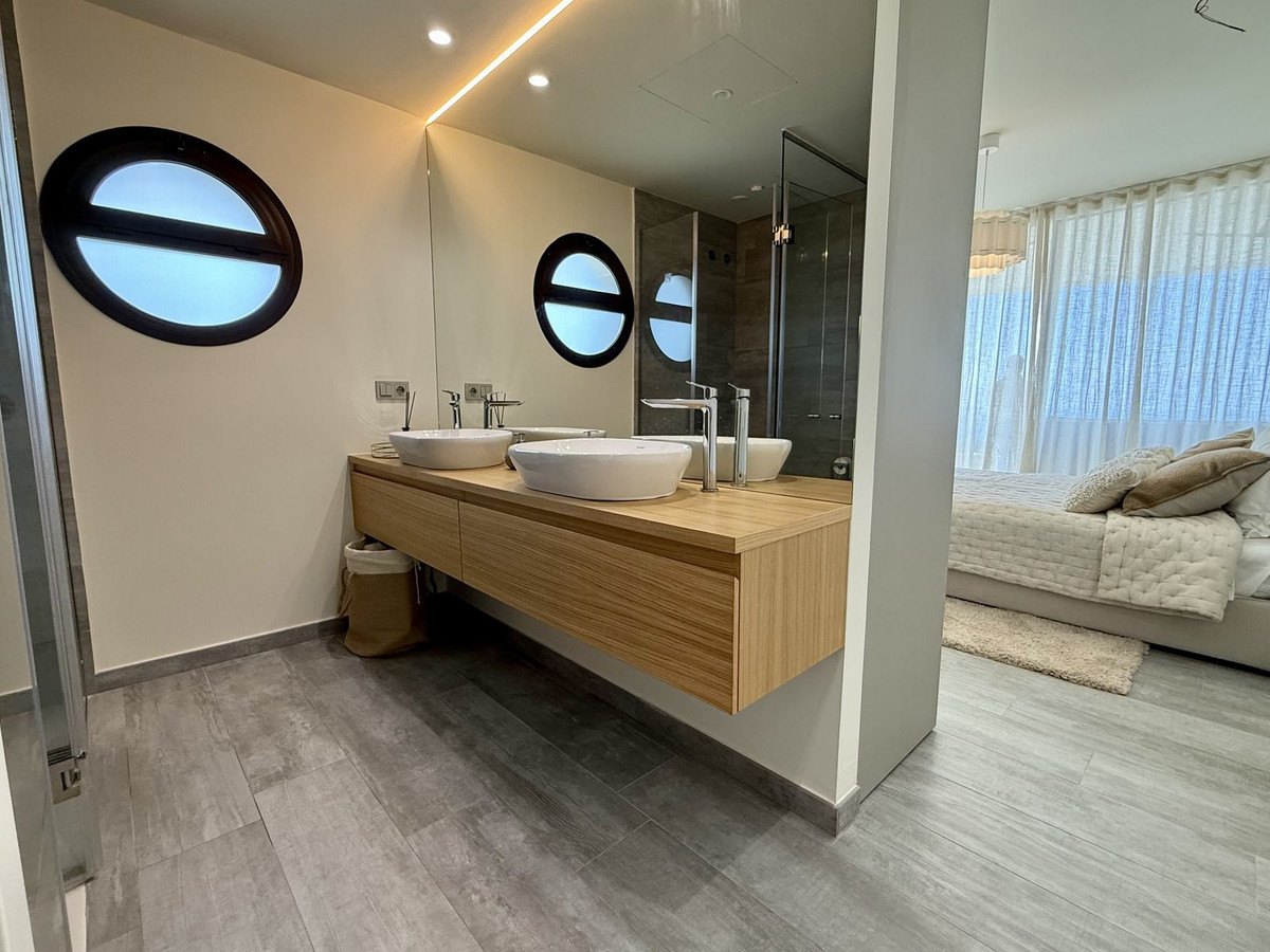 Bathroom with round windows over the basins