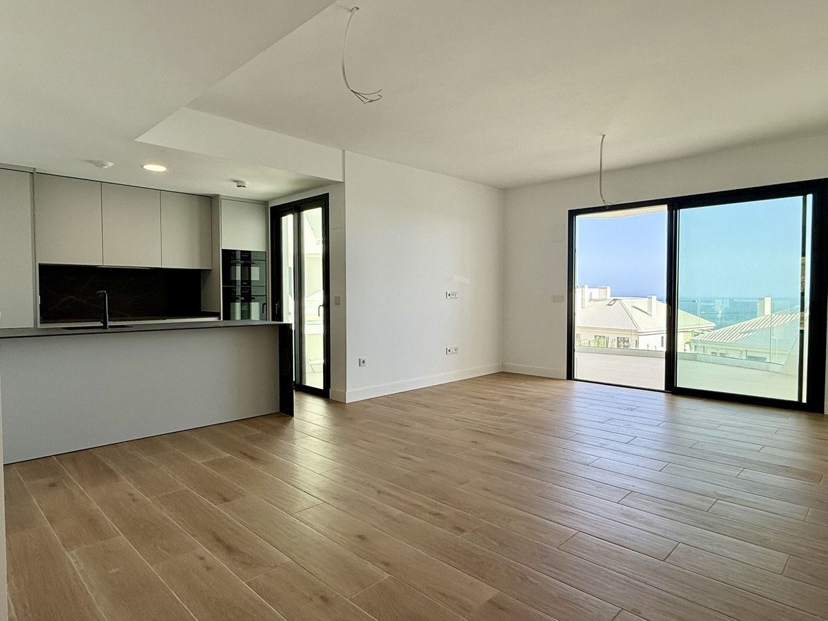 The living room and the kitchen, the terrace doors to the right