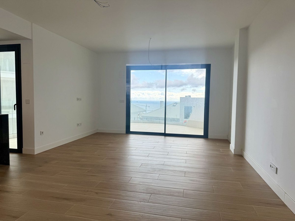 The living room, its glass wall facing south