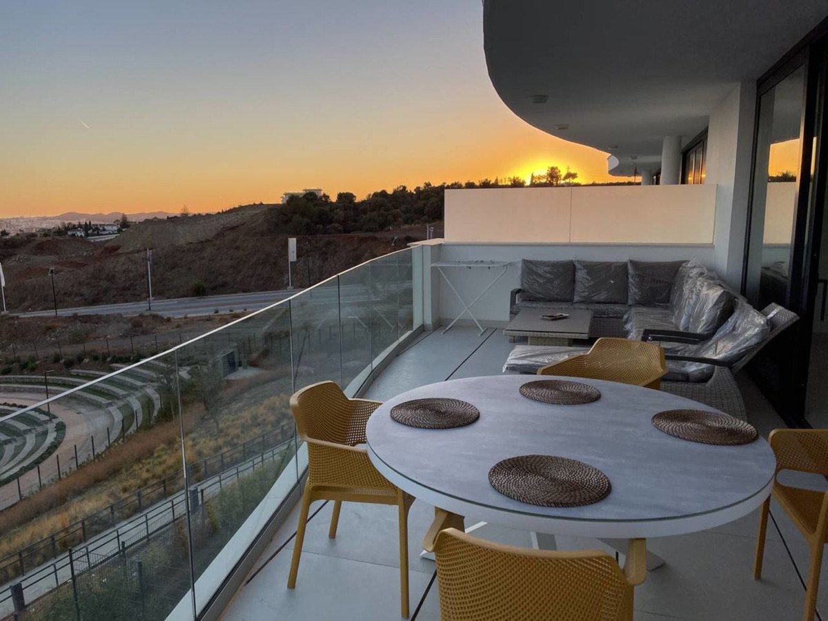 The terrace at sunset, the table laid and the sea beyond