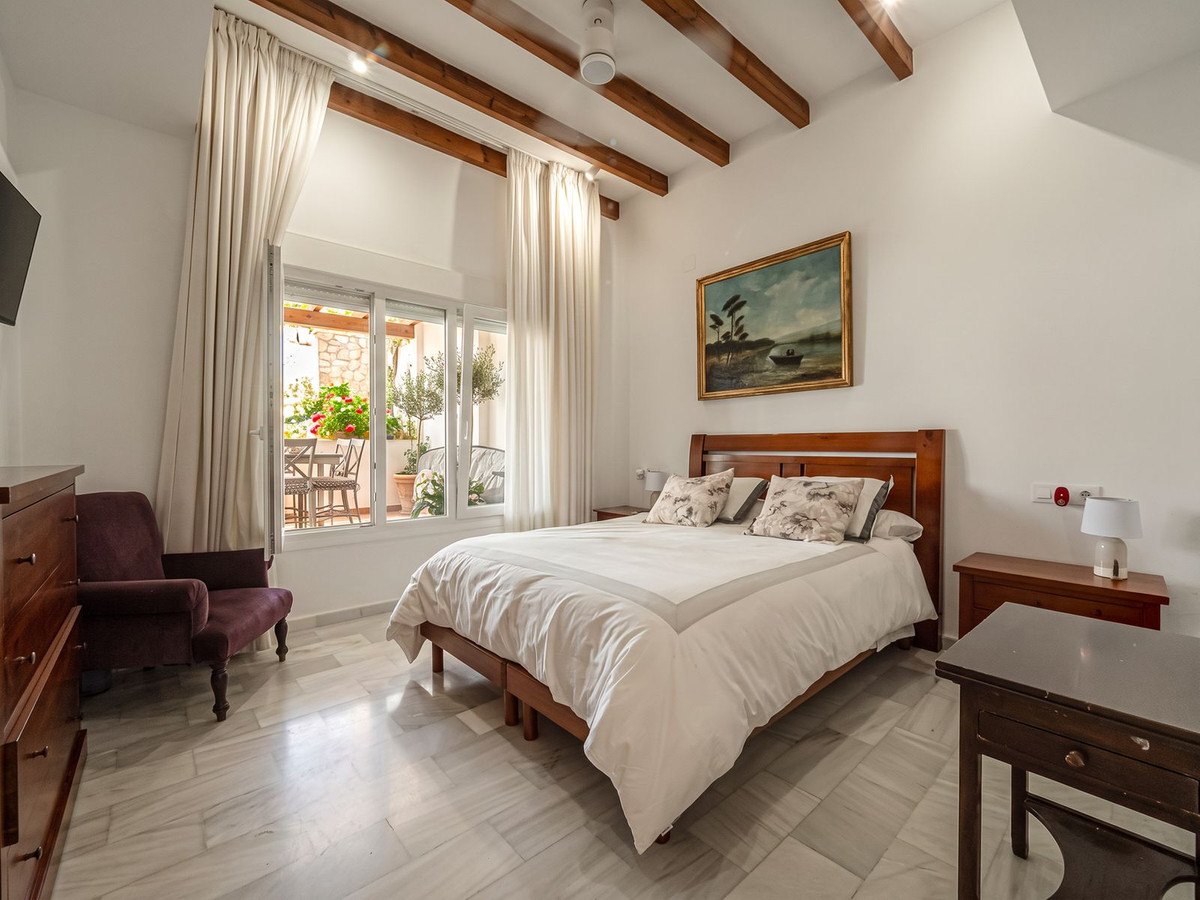 The master bedroom under its double-height ceiling