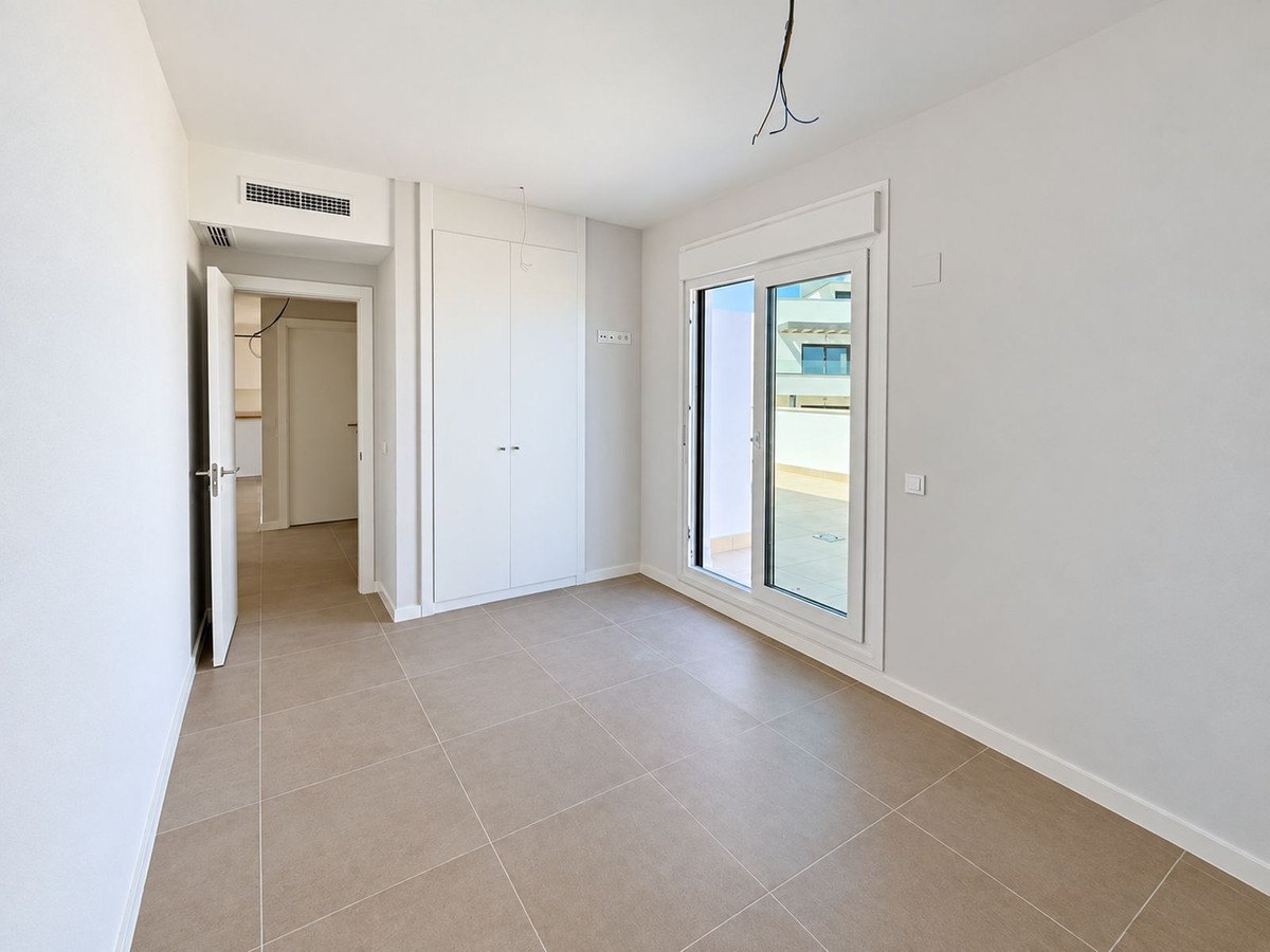 The living-dining room, its doors to the terrace