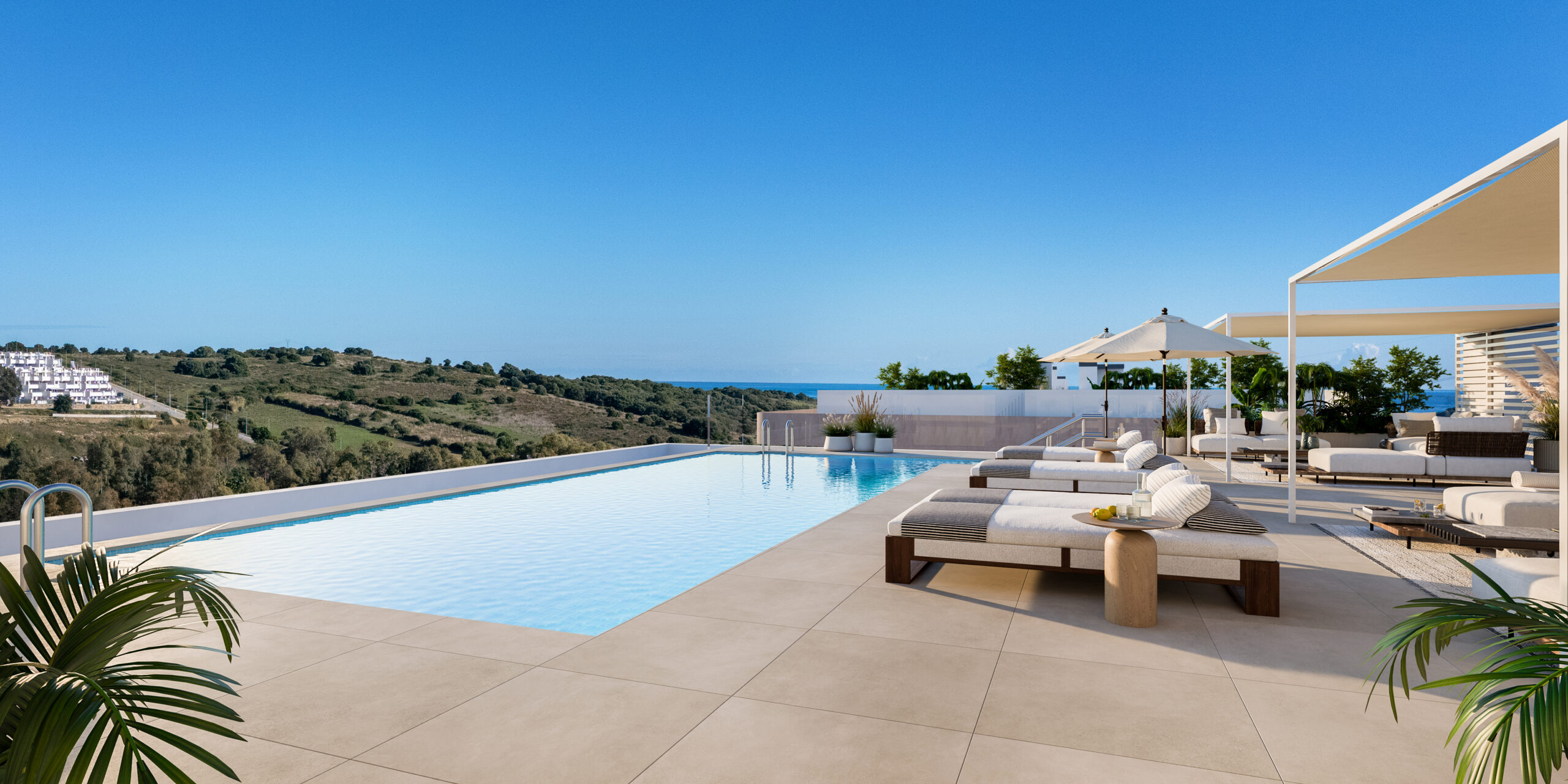 Rooftop solarium pool with the sea beyond